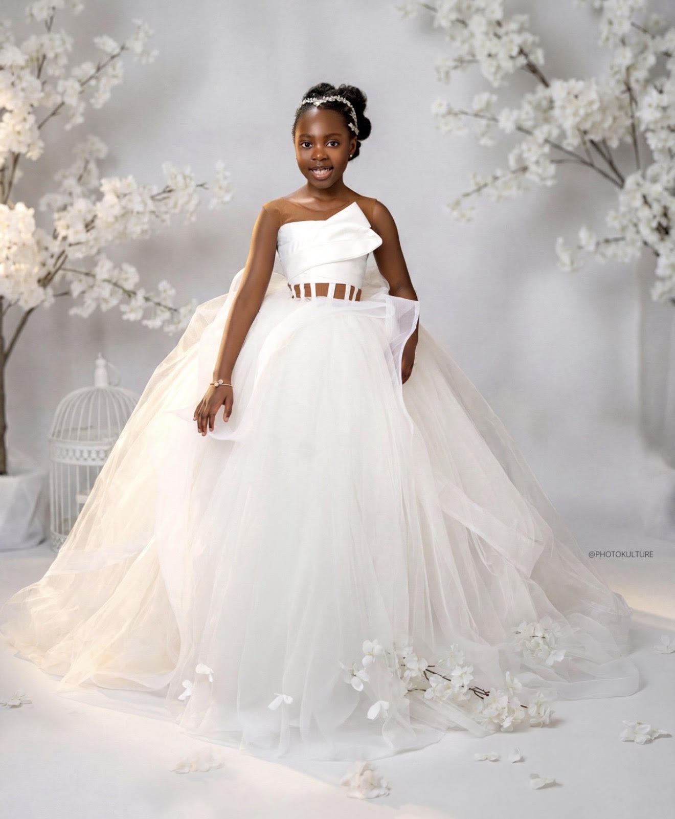 A DeLanie's ivory one-shoulder princess ball gown with a full tulle skirt